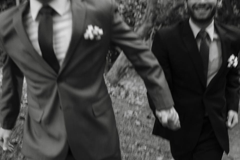 couple leaves wedding hand in hand